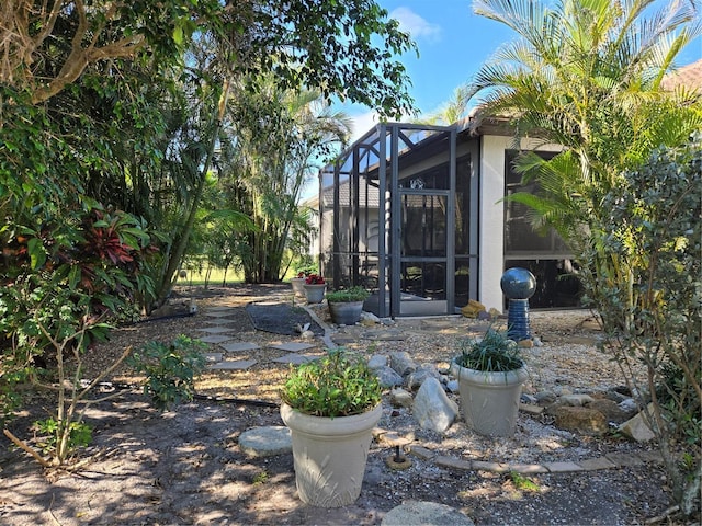 view of yard featuring glass enclosure