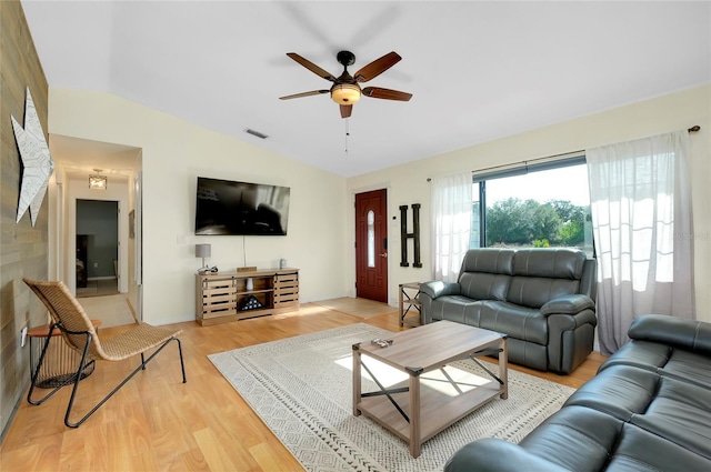 living room with light hardwood / wood-style flooring, ceiling fan, and lofted ceiling