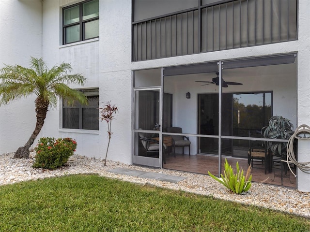 entrance to property with ceiling fan