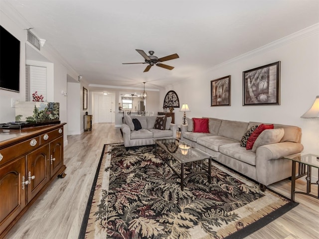 living room with ceiling fan, light hardwood / wood-style flooring, and ornamental molding