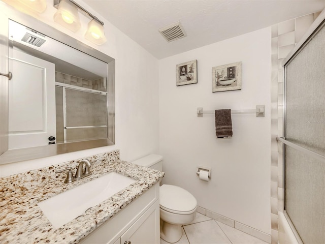 bathroom featuring tile patterned floors, vanity, and toilet