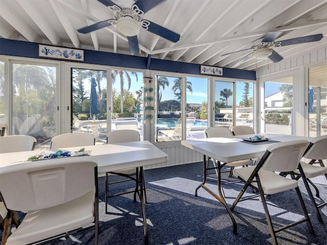 sunroom featuring ceiling fan, a healthy amount of sunlight, and beam ceiling