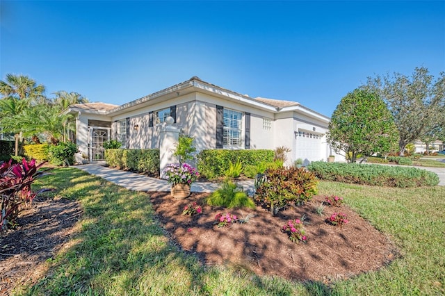 view of front of home with a garage, a front lawn, and stucco siding