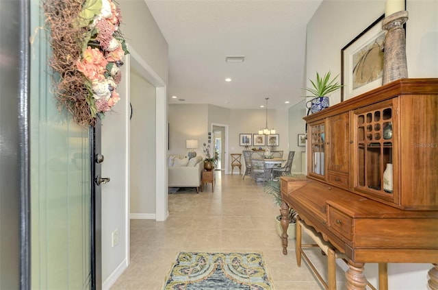 hall featuring recessed lighting, visible vents, baseboards, and light tile patterned floors