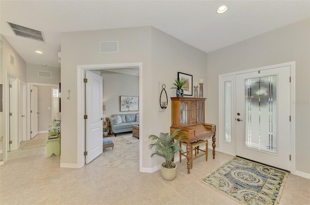 foyer entrance with light tile patterned floors, recessed lighting, visible vents, and baseboards