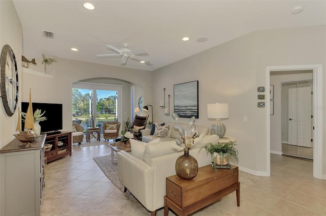 living area with arched walkways, light tile patterned floors, recessed lighting, a ceiling fan, and vaulted ceiling