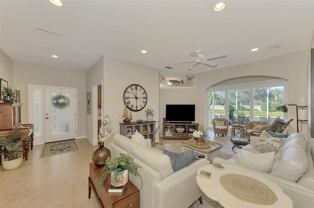 living area featuring light tile patterned floors, visible vents, a ceiling fan, and recessed lighting