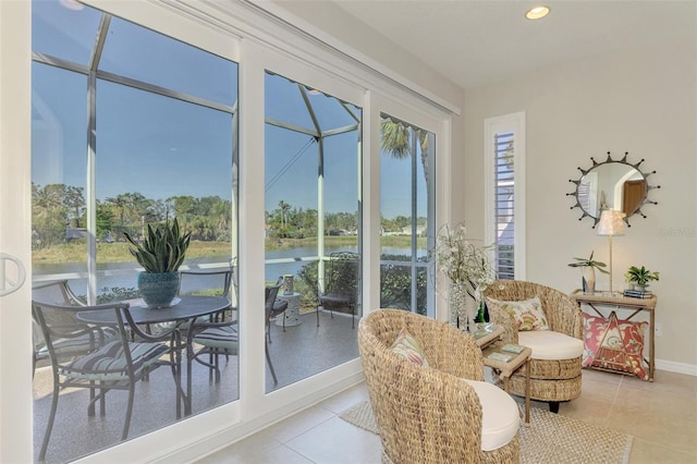 sunroom / solarium featuring a water view