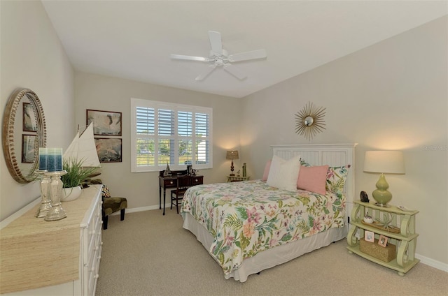 bedroom featuring light carpet, ceiling fan, and baseboards