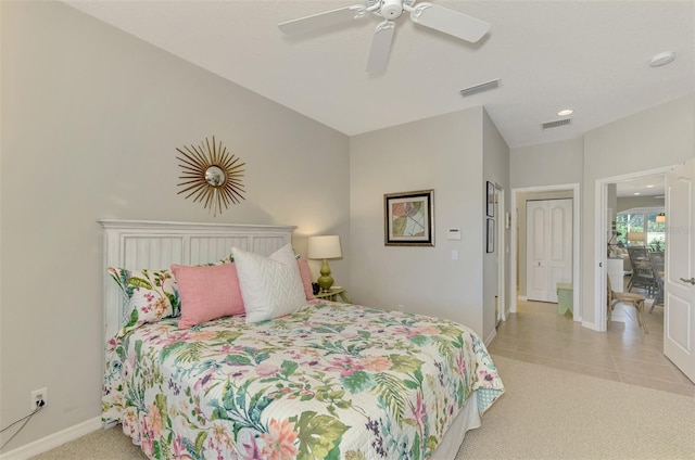 bedroom featuring light carpet, baseboards, visible vents, and ceiling fan