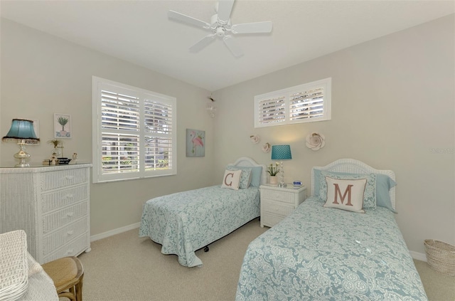 bedroom with baseboards, a ceiling fan, and light colored carpet