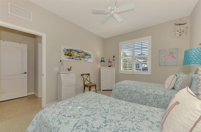 bedroom featuring baseboards, visible vents, a ceiling fan, and light tile patterned flooring