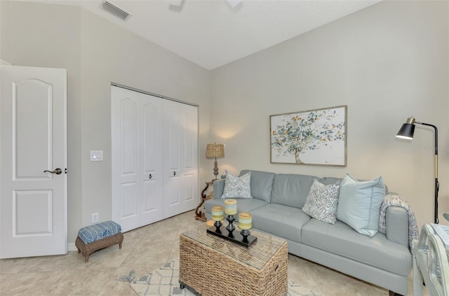 living room featuring visible vents and light tile patterned flooring