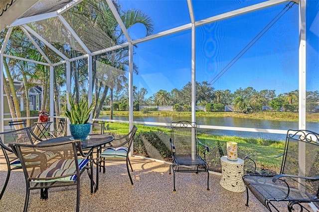 sunroom featuring a water view