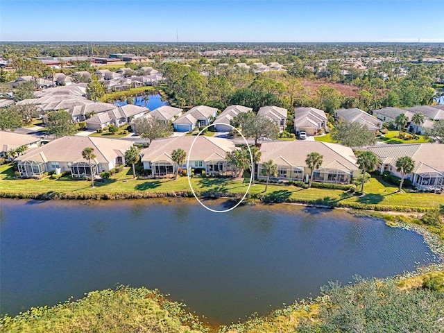 bird's eye view featuring a water view and a residential view