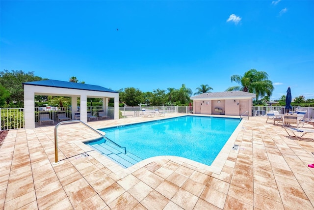 pool featuring a patio area, fence, and a gazebo