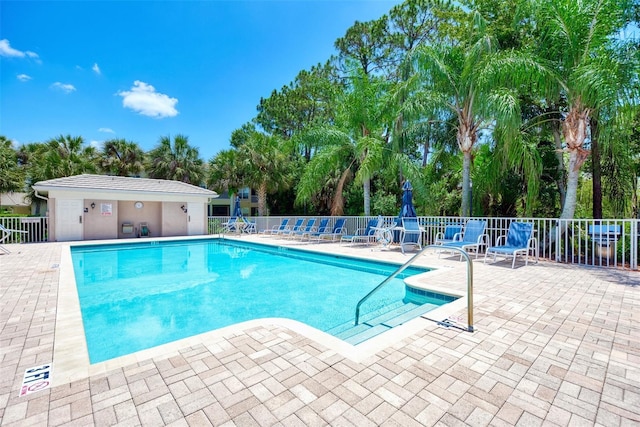 community pool featuring a patio area and fence