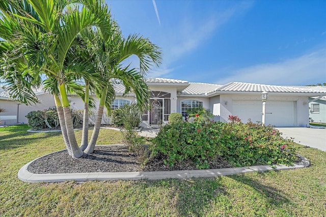 view of front of house with a front yard and a garage