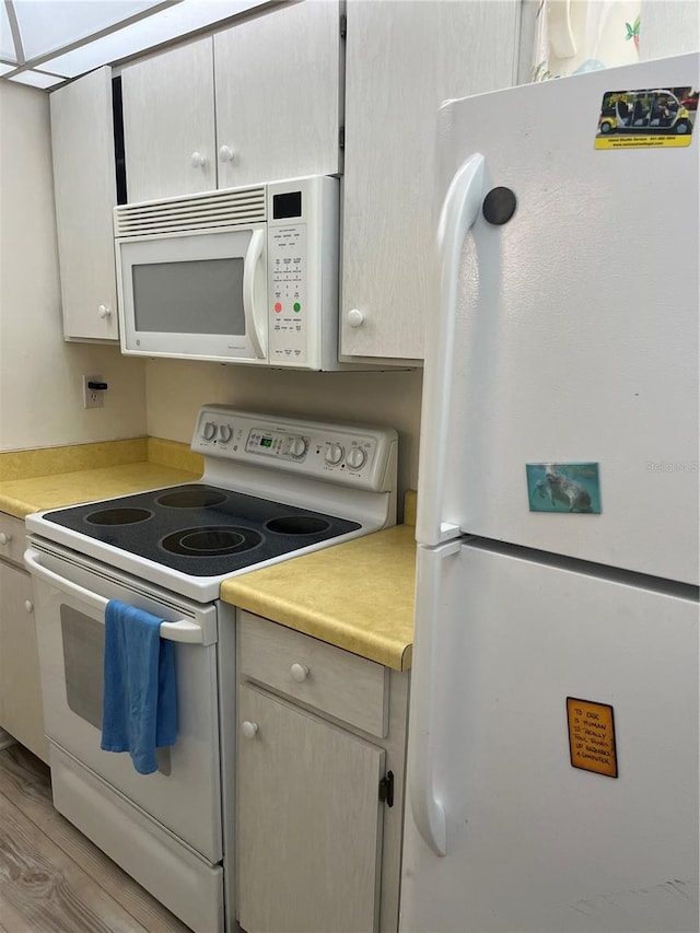 kitchen featuring white appliances and light wood-type flooring