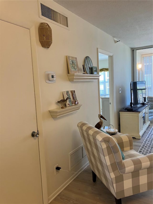 living room with hardwood / wood-style flooring and a textured ceiling