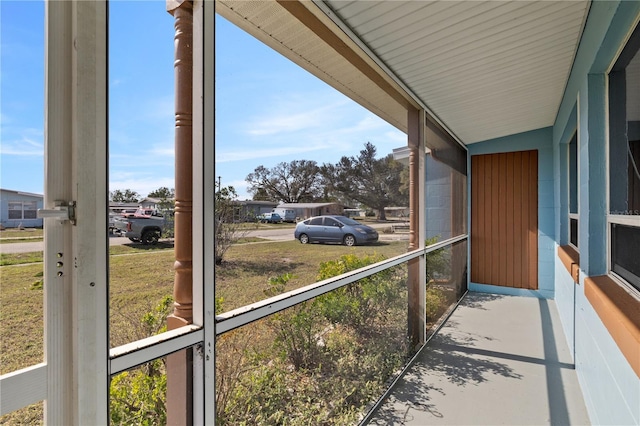 unfurnished sunroom with lofted ceiling