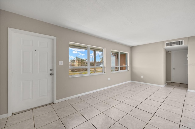 foyer featuring light tile patterned floors