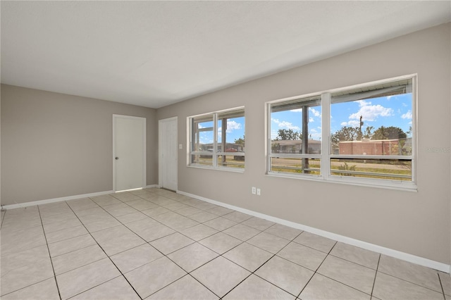 unfurnished room with light tile patterned floors