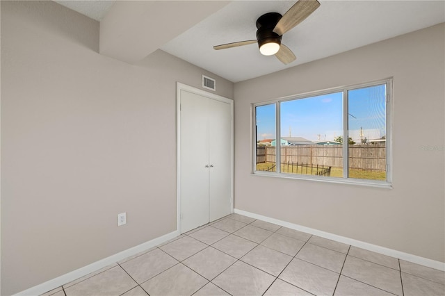 unfurnished room featuring ceiling fan and light tile patterned flooring