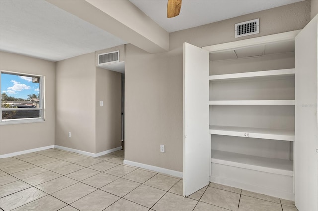 interior space with ceiling fan