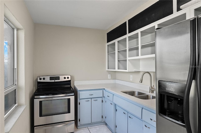 kitchen with light tile patterned floors, stainless steel appliances, and sink