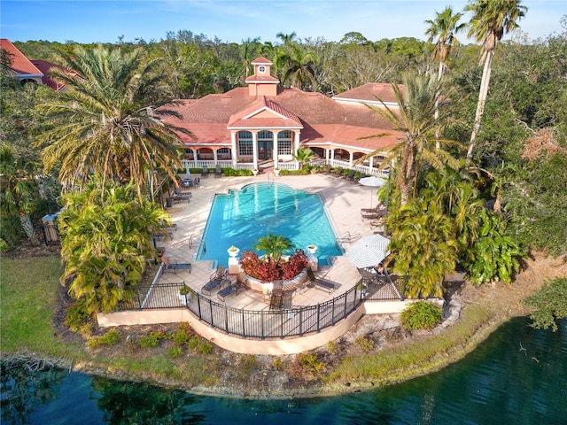 view of swimming pool featuring a water view and a patio area