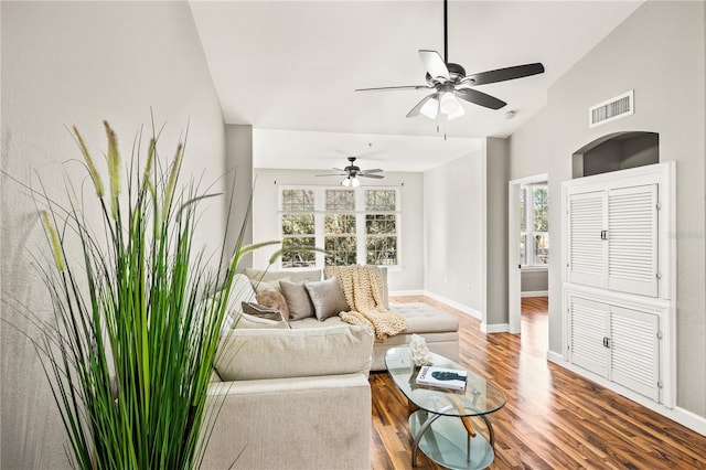 living room with ceiling fan, hardwood / wood-style floors, and vaulted ceiling