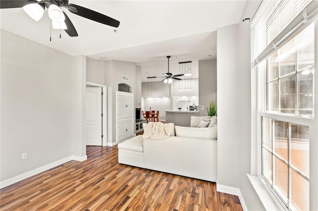 living room featuring wood-type flooring and ceiling fan