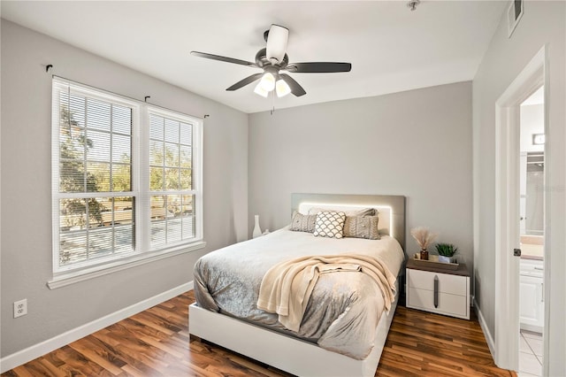 bedroom featuring ensuite bathroom, ceiling fan, and dark hardwood / wood-style floors