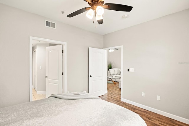 bedroom with light hardwood / wood-style floors and ceiling fan