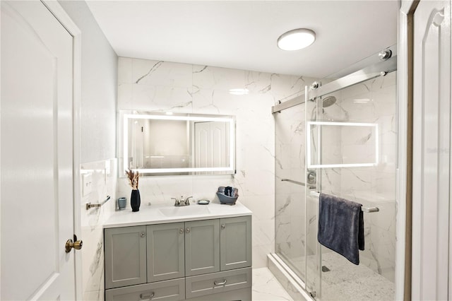 bathroom with vanity, walk in shower, and tile walls