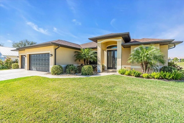 view of front of property with a garage and a front yard