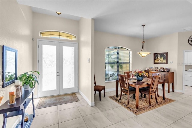 tiled foyer with washer / clothes dryer and french doors