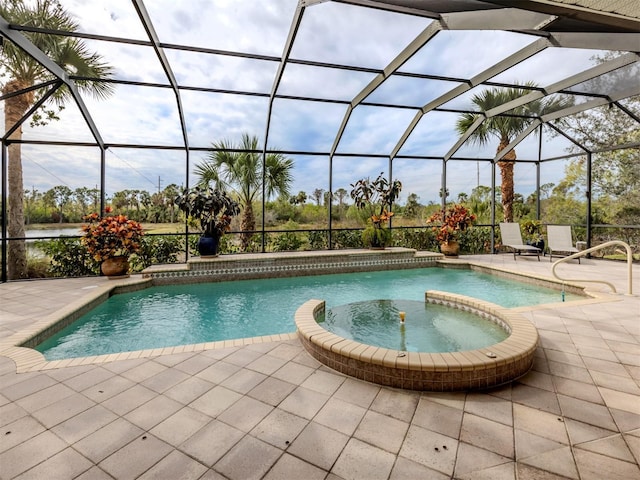 view of pool with an in ground hot tub, a lanai, and a patio area