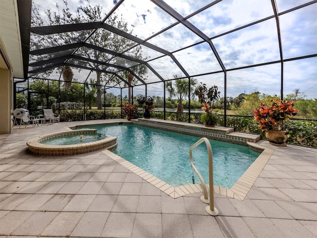 view of pool featuring an in ground hot tub, a lanai, and a patio