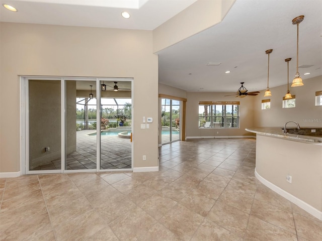 interior space with sink and ceiling fan