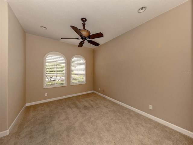 carpeted empty room featuring ceiling fan