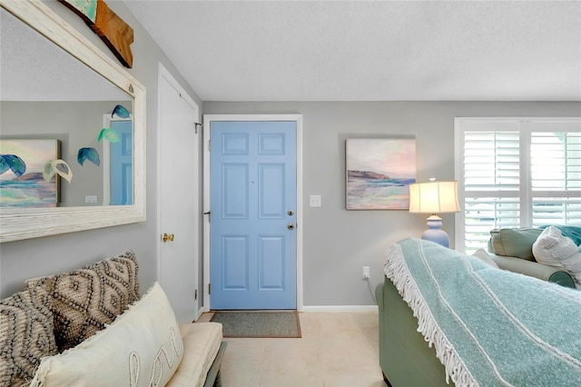 interior space featuring a textured ceiling and light tile patterned flooring