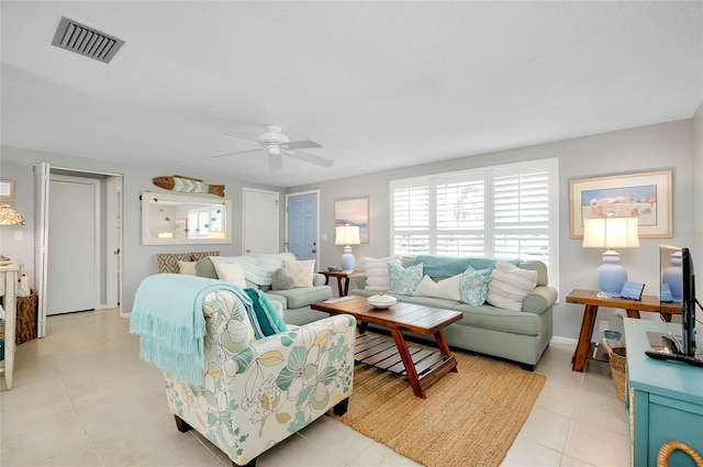 tiled living room featuring ceiling fan