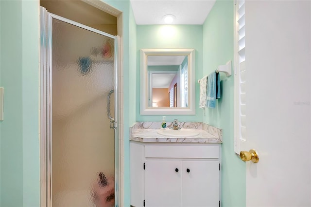 bathroom with vanity and a shower with shower door