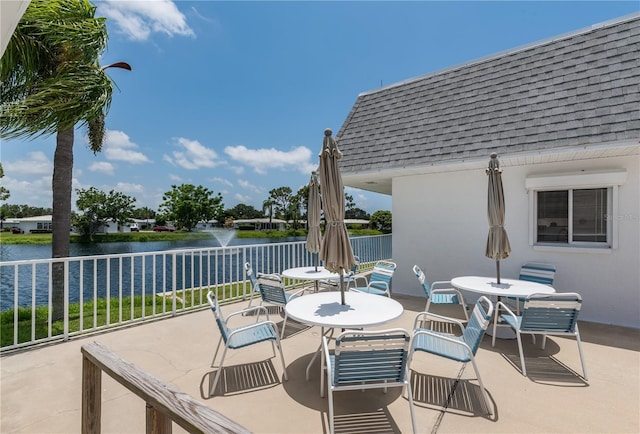 view of patio with a water view