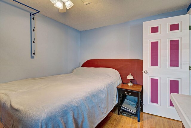 bedroom featuring ceiling fan and hardwood / wood-style floors