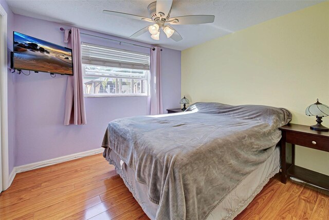 bedroom with ceiling fan and light wood-type flooring