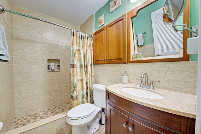 bathroom featuring backsplash, curtained shower, vanity, and toilet