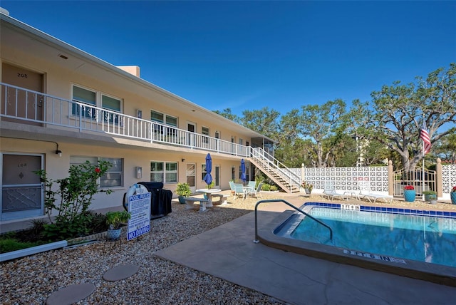 view of pool with area for grilling and a patio area